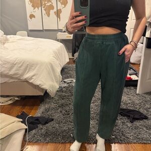 Green thick sweatpants with pull ties at the bottom